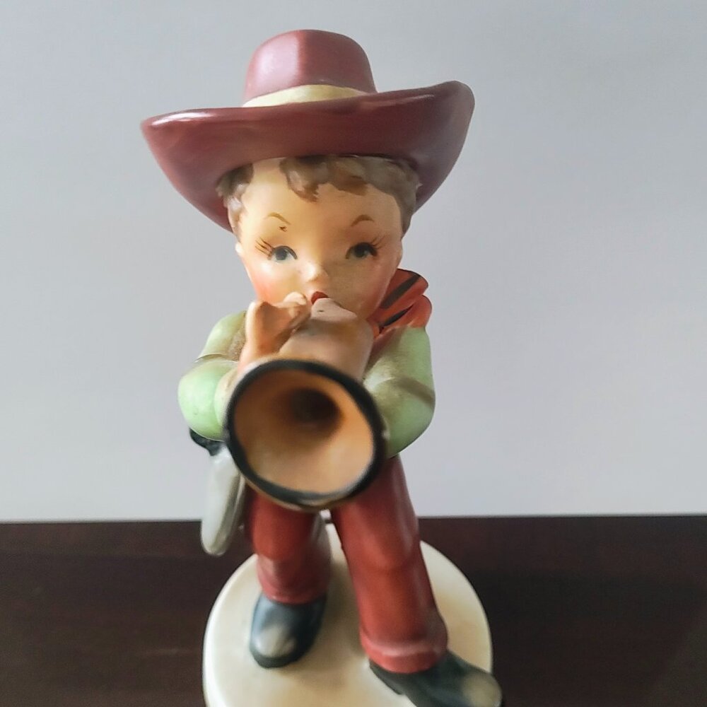 BOY PLAYING HORN FIGURINE